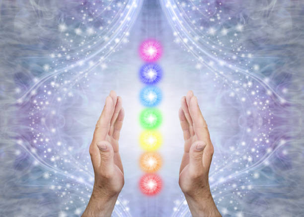 A picture of hands around the 7 chakra colours in a line 