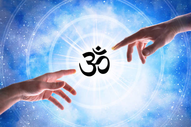 2 hands pointing towards an om symbol