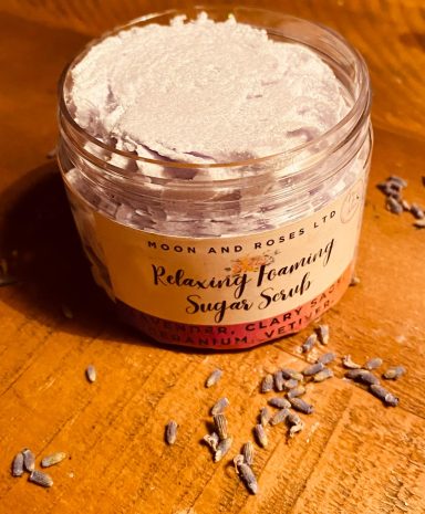 An open pot of Relaxing Whipped SUgar Scrub, it is lilac and whipped with a little bit of glitter on top
