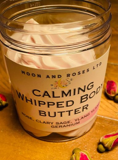 A pot of whipped body butter which is pale pink