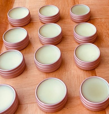 12 small rose gold pots with balm inside them